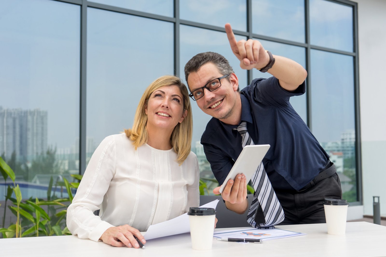 relaxed male and female managers working in cafe outdoors